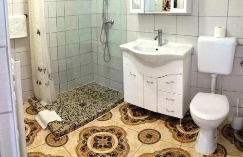 a bathroom with a sink and a toilet at Garden House in Budapest