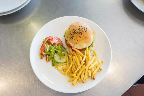 a plate of food with a sandwich and french fries at Kili Seasons Hotel in Arusha