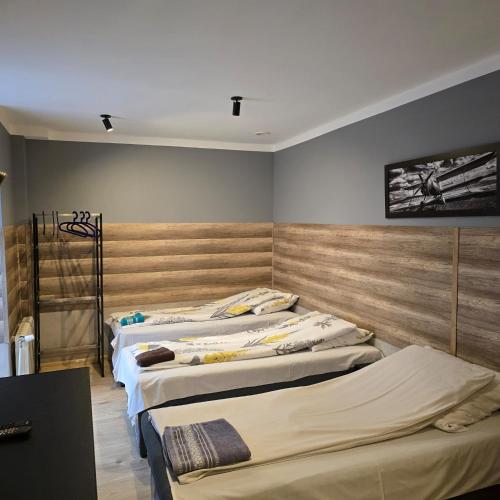 a group of three beds in a room at Pokoje Gościnne Polo in Częstochowa