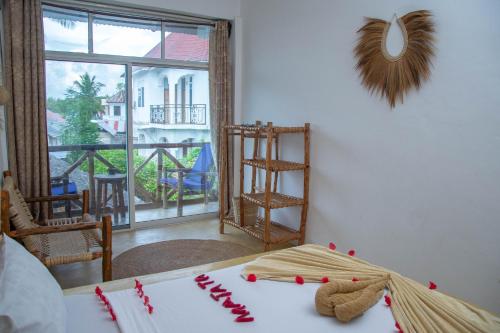 a room with a table with red candies on it at Equalia Rose Hotel in Jambiani