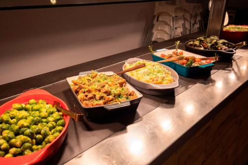 a buffet with several dishes of food on a counter at Hotel Piolets Soldeu Centre by Nexta in Soldeu