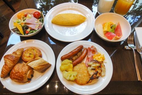 a table with plates of breakfast food on it at Ambassador Hanoi Hotel & Spa in Hanoi