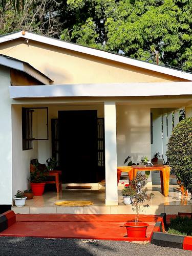a small house with a red carpet in front of it at Kivuli Lodge in Moshi