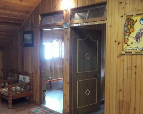 a wooden hallway with a door in a room at Himalayan tea pot in Darjeeling