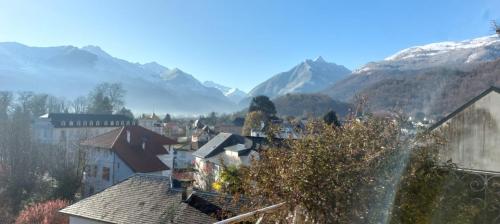 a view of a town with mountains in the background at Logis Hôtel Beau Site in Argelès-Gazost