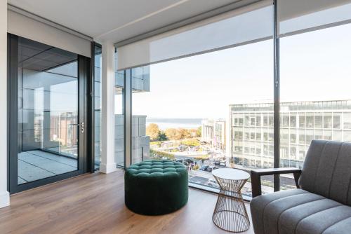 a living room with a couch and a large window at Alto Frascati Blackrock in Blackrock
