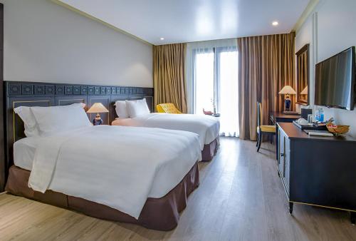 Postel nebo postele na pokoji v ubytování Hotel Sapa Square Affiliated by Melia