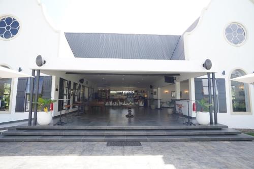 a large white building with a courtyard with a book store at Kili Seasons Hotel in Arusha