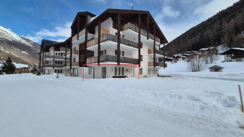 a large building in the snow in the snow at Quiet corner with charm in Obergesteln in Obergesteln