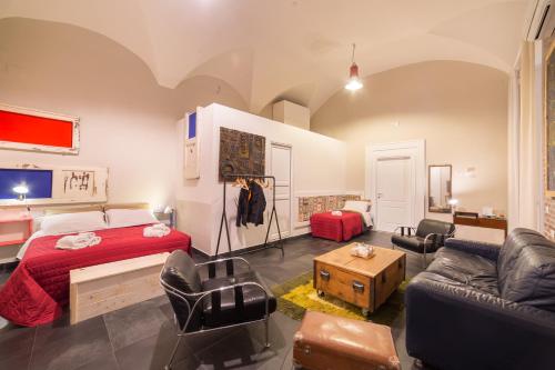 a bedroom with a bed and a living room with a couch at The Bellini House by House In Naples in Naples