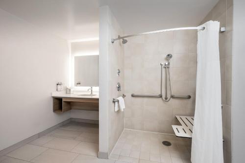 a bathroom with a shower and a sink at Staybridge Suites North Charleston by IHG in Charleston