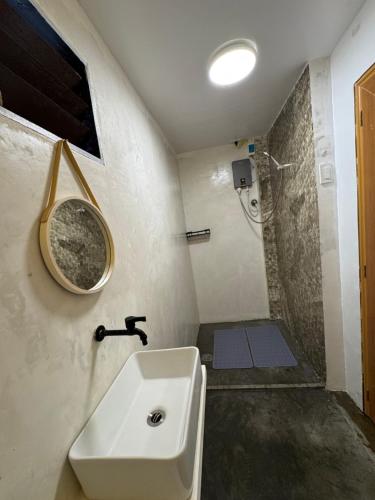 a bathroom with a sink and a shower at NUTMEG Cottage Siargao- Private room in General Luna