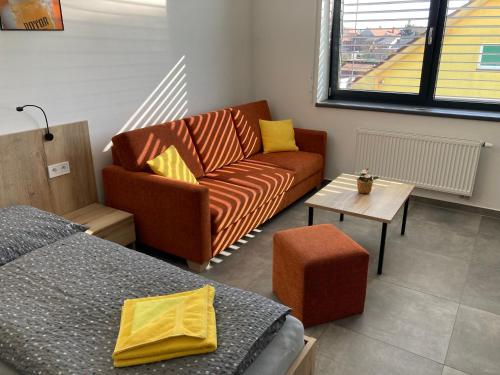 a living room with a couch and a bed at New Pension at ROTOR Brewery in Kunovice