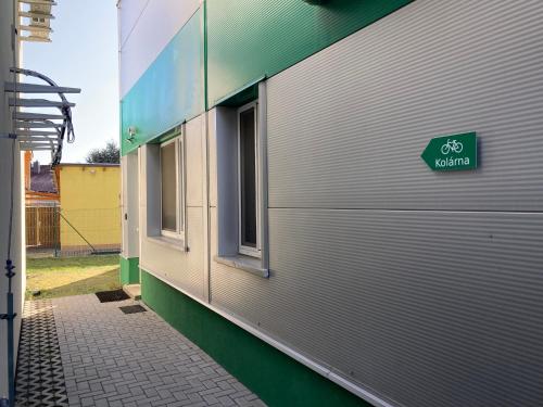a side of a building with a bike sign on it at New Pension at ROTOR Brewery in Kunovice