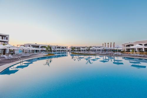 a large pool of blue water in a resort at Blue Lagoon Queen in Kalyves Poligirou