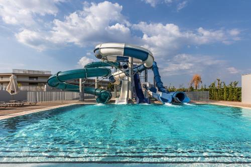 a water slide in the middle of a swimming pool at Blue Lagoon Queen in Kalyves Poligirou