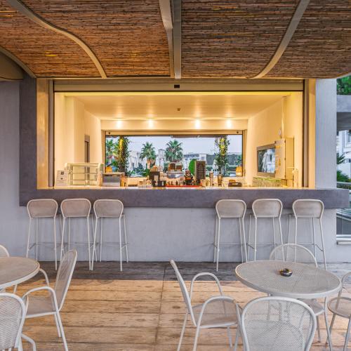 a restaurant with tables and chairs and a bar at Blue Lagoon Queen in Kalyves Poligirou