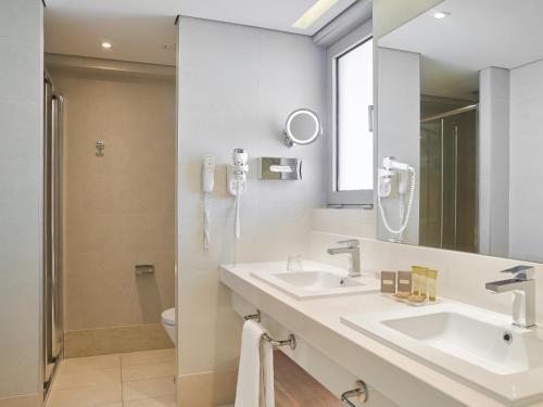 a bathroom with two sinks and a mirror at Blue Lagoon Queen in Kalyves Poligirou