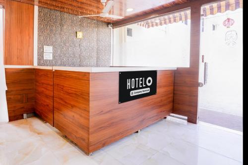 a room with a hotel sign on the wall at Super Hotel O Palava Dombivali in Mangrul