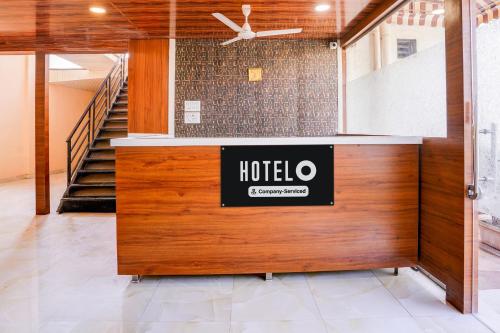 a hotel lobby with a sign on the wall at Super Hotel O Palava Dombivali in Mangrul