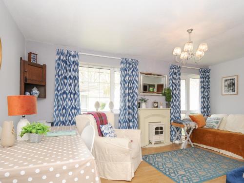 a living room with blue and white curtains at No 1 The Heathers in Saint Cleer