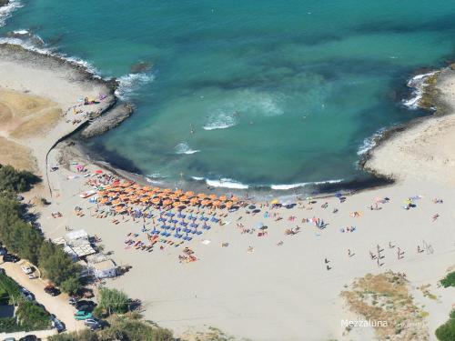 an overhead view of a beach with people and umbrellas at Al Ristoro in Torre Santa Sabina