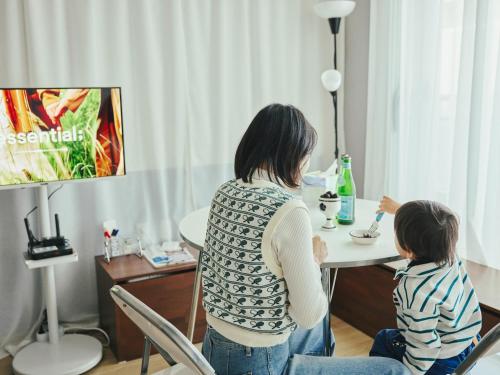 a woman and a child sitting at a table at Stay Hankan 모던코리아라이프 in Seoul