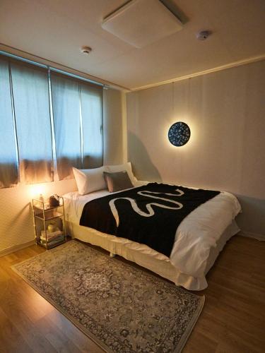 a bedroom with a large bed and a window at Stay Hankan 모던코리아라이프 in Seoul