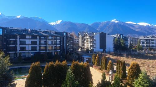 a city with buildings and mountains in the background at Pirin Views Aspen A337 in Razlog