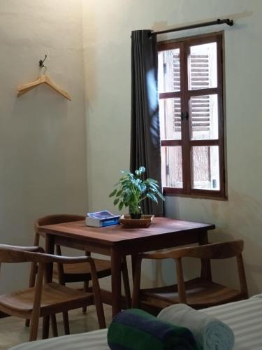 a table with a plant on it in a room at Blue Garden Yogyakarta in Yogyakarta