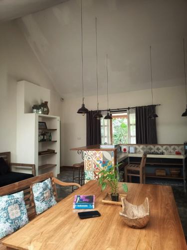 a living room with a wooden table and chairs at Blue Garden Yogyakarta in Yogyakarta