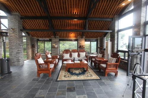 a living room with chairs and tables and a fireplace at Home of the Great Wall in Huairou