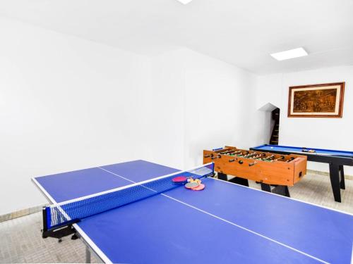 a ping pong room with two ping pong tables at Encantadora casa familiar in Liérganes