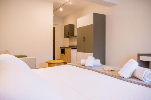 a bedroom with a white bed with towels on it at Imathoessa in Gialova