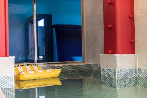 a bathroom with a mirror and a yellow object at From H Brown Dot Hotel Gyeongju Yangnam in Gyeongju