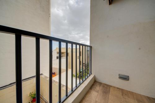 a balcony with a view of a building at Modern Marsaxlokk Apartment in Marsaxlokk