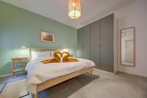 a bedroom with a bed with a towel on it at Modern Marsaxlokk Apartment in Marsaxlokk