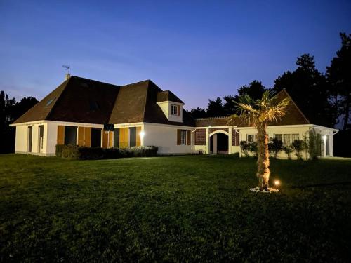 une maison avec un palmier dans la cour dans l'établissement Domaine idyllique Phamily House, à Senonches