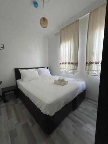 a bedroom with a bed with two towels on it at Çağlar my hause apart otel in Turgutreis