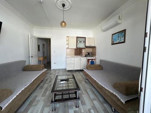 a living room with two couches and a table at Çağlar my hause apart otel in Turgutreis