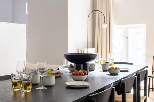 a table with food and wine glasses on it at Unique 3 Bedroom Apartment in Vibrant Frederiksberg in Copenhagen