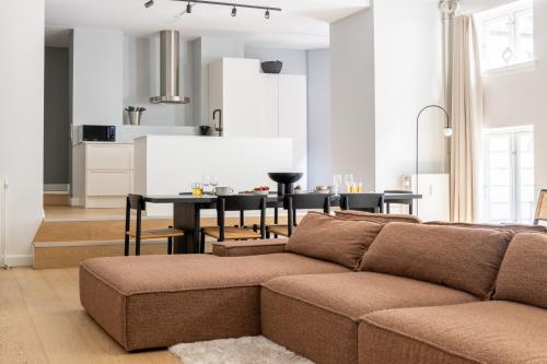 a living room with a couch and a table at Unique 3 Bedroom Apartment in Vibrant Frederiksberg in Copenhagen