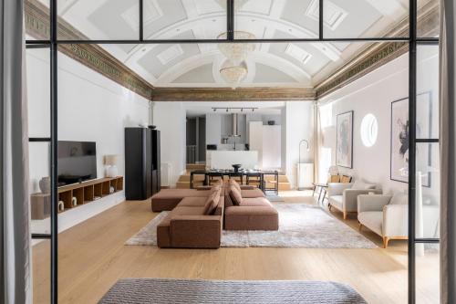 a living room with a couch and a table at Unique 3 Bedroom Apartment in Vibrant Frederiksberg in Copenhagen
