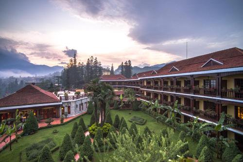 a resort with a courtyard with trees and buildings at Sapa Mountain Resort Affiliated by Melia in Sa Pa