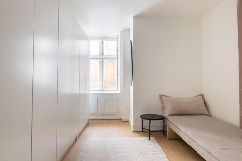 a living room with a couch and a window at Unique 3 Bedroom Apartment in Vibrant Frederiksberg in Copenhagen