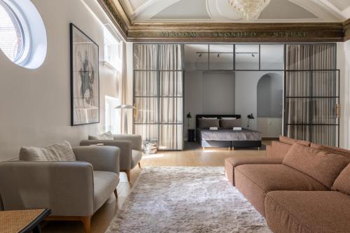 a living room with a couch and a bed at Unique 3 Bedroom Apartment in Vibrant Frederiksberg in Copenhagen