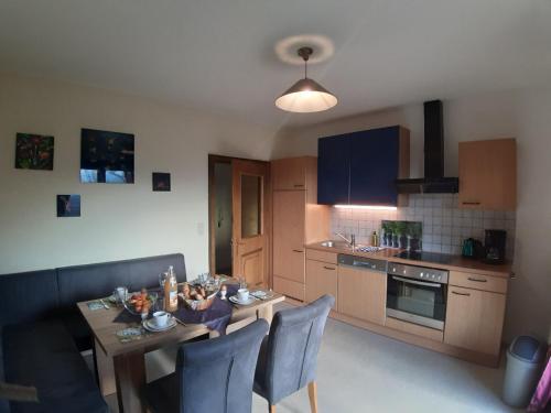 a kitchen with a table and chairs and a dining room at Landhaus Bonaventura in Millstatt