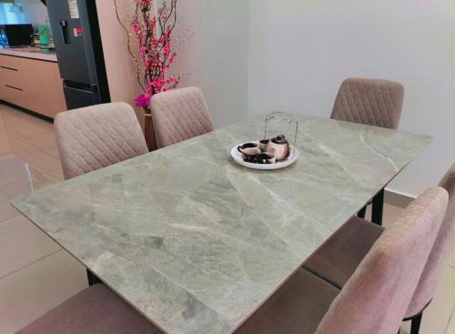 a dog is sitting in a bowl on a table at New Akina Kajang2 Homestay 12pax in Semenyih