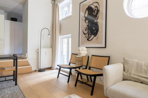 a living room with a couch and chairs at Unique 3 Bedroom Apartment in Vibrant Frederiksberg in Copenhagen