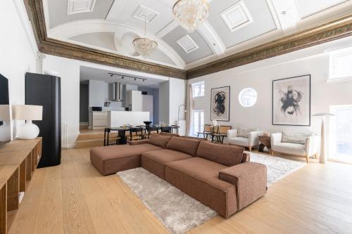 a living room with a couch and a dining room at Unique 3 Bedroom Apartment in Vibrant Frederiksberg in Copenhagen